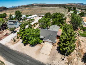 Aerial view of property and surrounding area with a mountainous background