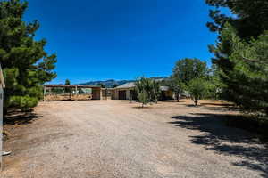 View of front of house featuring a mountain view and gravel driveway