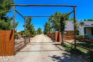 View of dirt / gravel road with a gate and a gated entry