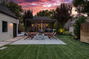 Patio terrace at dusk with a patio area, grilling area, and an outdoor fire pit