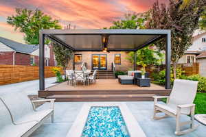 Back of house featuring french doors, a deck, brick siding, an outdoor living space, and outdoor dining area