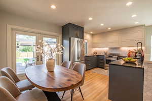 Dining area with recessed lighting and light wood-style floors