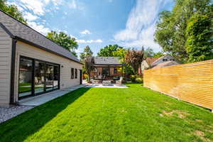 Fenced yard featuring a patio and an outdoor hangout area