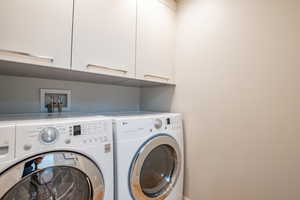 Laundry area with washer and dryer and cabinet space