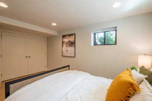 Bedroom with recessed lighting and a closet