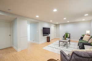 Living room with recessed lighting and cork flooring.