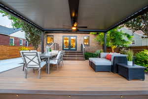 Wooden deck with french doors, outdoor dining area, and an outdoor hangout area