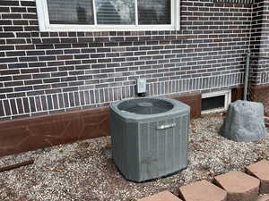 Exterior view of a central air condition unit and brick siding