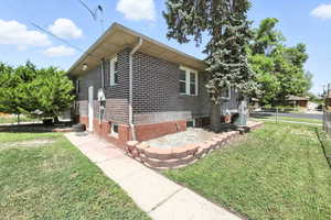 View of home's exterior with brick siding and a cooling unit