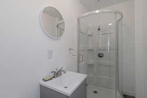 Bathroom featuring a shower stall and vanity
