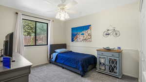 Carpeted bedroom with ceiling fan