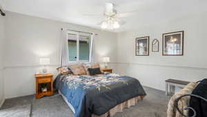 Master bedroom with ceiling fan and Door to covered patio