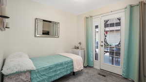 Bedroom featuring carpet and access to exterior covered patio
