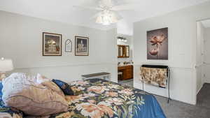 Master bedroom with light carpet and ensuite bath