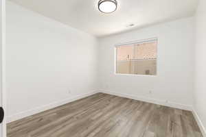 Unfurnished room featuring light wood-style flooring and baseboards