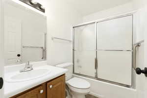 Full bathroom with vanity and shower / bath combination with glass door
