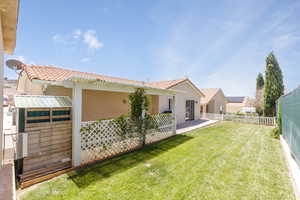 Fenced backyard with a patio area