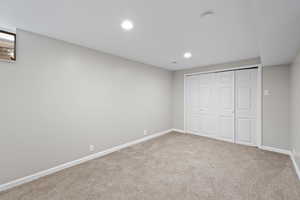Unfurnished bedroom with carpet floors, recessed lighting, and a closet