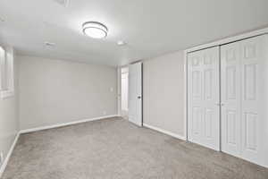 Unfurnished bedroom with carpet floors and a closet