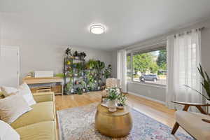 Living area with wood finished floors and baseboards