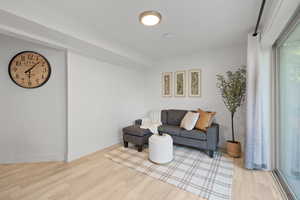Living area with wood finished floors and plenty of natural light
