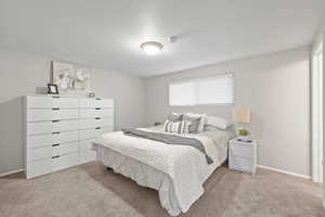 Carpeted bedroom featuring baseboards