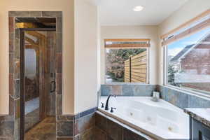 Bathroom featuring a jetted tub, a shower stall, recessed lighting, and vanity