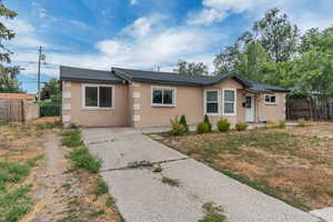 Single story home with stucco siding and roof with shingles
