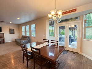 Dining space featuring a chandelier, wood finished floors, and recessed lighting