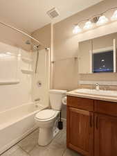 Bathroom featuring tile patterned flooring, vanity, and tub / shower combination