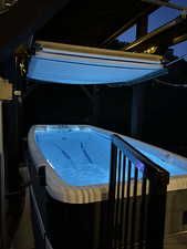 View of pool with a hot tub