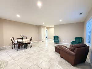 Living area with recessed lighting and light tile patterned floors. Mother in law apartment.
