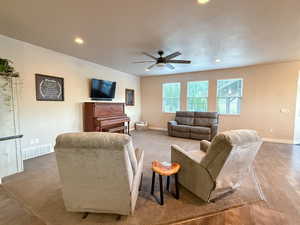 Living room with ceiling fan, recessed lighting, and wood finished floors