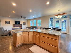 Kitchen with open floor plan, dark wood-style floors, a chandelier, recessed lighting, and ceiling fan