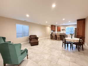 Dining space with recessed lighting and light tile patterned flooring