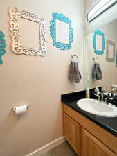 Bathroom with tile patterned floors and vanity