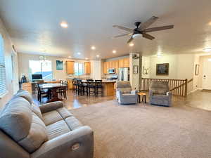 Living room featuring recessed lighting, a ceiling fan, and a textured ceiling