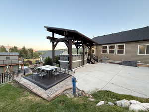 Patio terrace at dusk with a patio and outdoor dining area