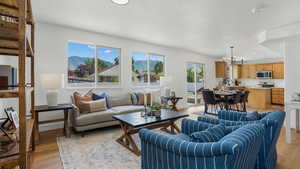 Living area featuring light wood-style floors, a mountain view, a chandelier, and recessed lighting