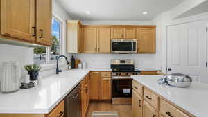 Kitchen featuring stainless steel appliances, light wood-style floors, light countertops, and recessed lighting