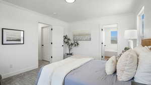 Bedroom with crown molding, carpet floors, and ensuite bathroom