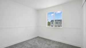 Carpeted spare room with baseboards and crown molding
