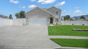 Traditional-style house with a gate, stucco siding, a garage, concrete driveway, and a mountain view