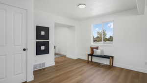 Empty room featuring wood finished floors and a textured ceiling