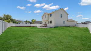 Back of property with a patio area, a fenced backyard, and entry steps