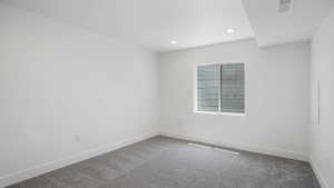 Unfurnished room featuring carpet flooring and recessed lighting
