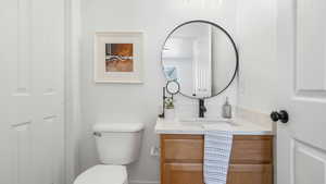 Half bathroom with vanity and toilet