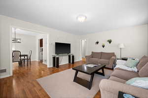 Living area with wood finished floors and baseboards