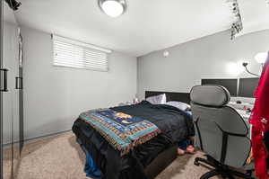 Carpeted bedroom with a desk
