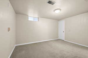 Basement featuring carpet flooring and baseboards